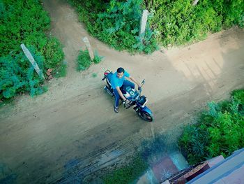 High angle view of people riding motorcycle on road