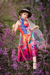 Portrait of young woman standing on field