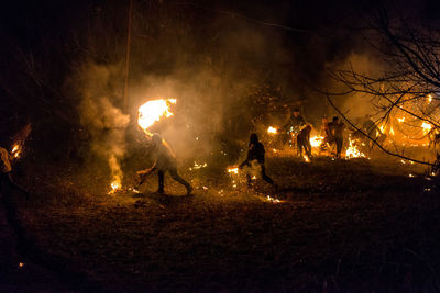 Group of people against fire at night