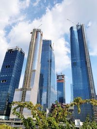 Low angle view of buildings against cloudy sky