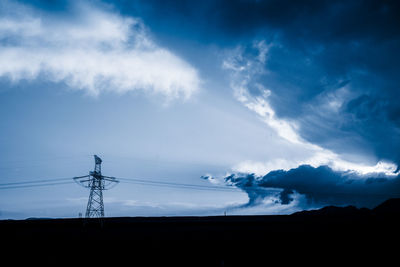 High voltage towers with sky background.