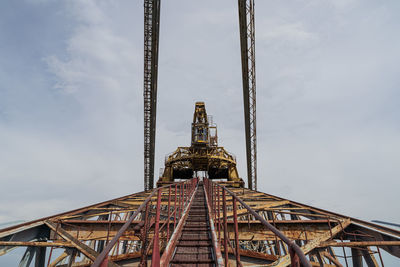 Low angle view of ferris wheel against building