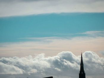 Low angle view of built structure against cloudy sky