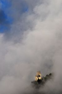 Low angle view of building against cloudy sky