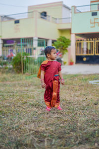 Full length of boy standing on field