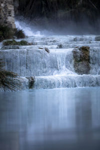 Surface level of water flowing over rocks in sea