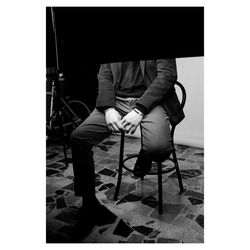 Low section of people sitting on chair