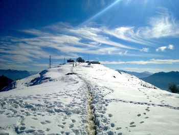 Scenic view of snow covered mountains against sky