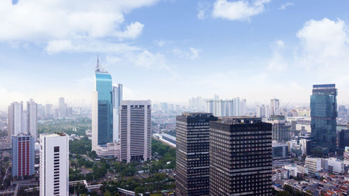 Modern buildings in city against sky