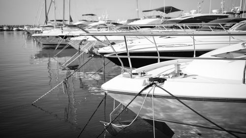 Boats moored in sea against sky