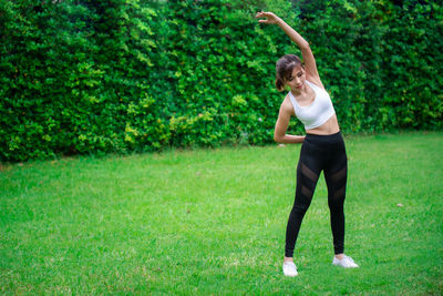 Full length of woman standing on grass