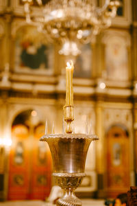 Close-up of illuminated candles on table