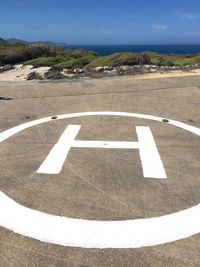 High angle view of helipad symbol on land