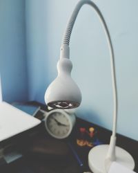 Close-up of electric lamp on table at home