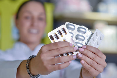 Close up of medicine holding by female pharmacist 