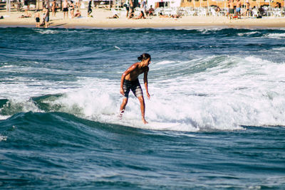 Full length of man surfing in sea