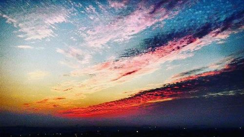 Scenic view of dramatic sky at sunset