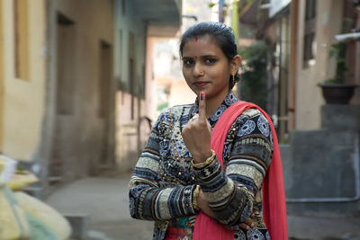 Indian woman showing finger mark after polling, casting vote, india