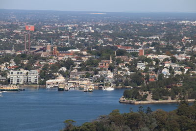 High angle view of buildings by sea against sky