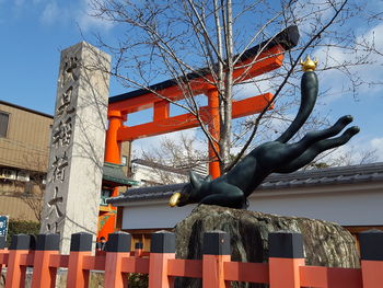 Low angle view of statue against buildings in city