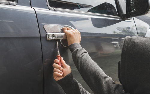 Burglar breaking car door