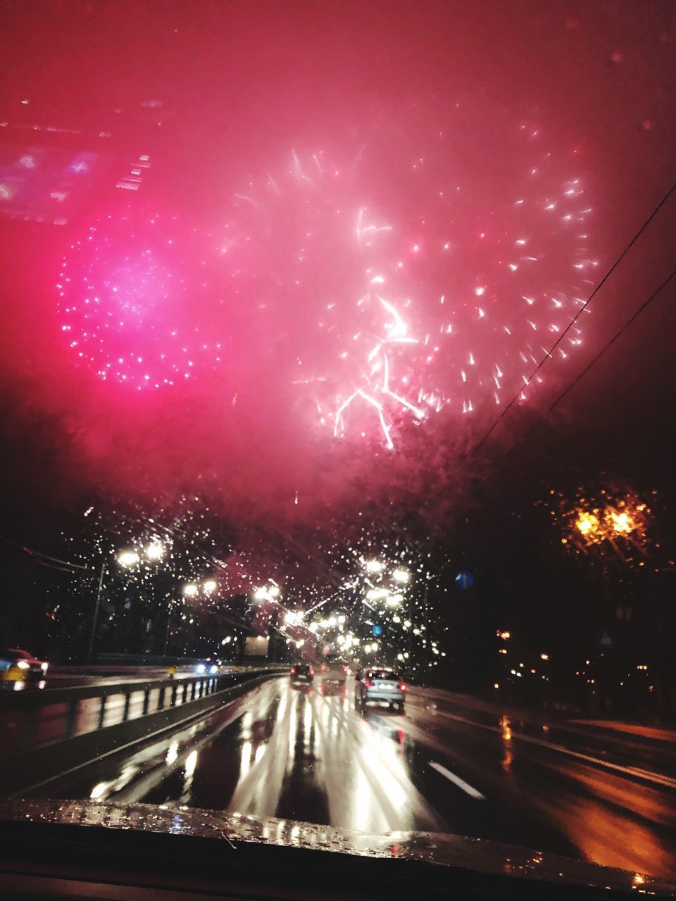 VIEW OF ILLUMINATED STREET AT NIGHT