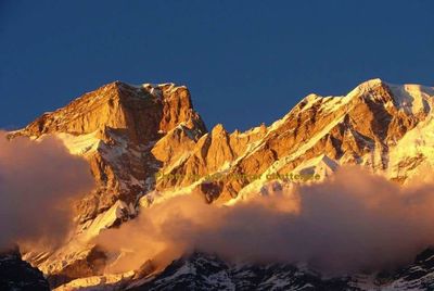 Scenic view of mountains against clear blue sky