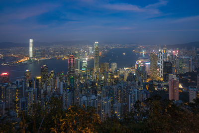 High angle view of illuminated cityscape against sky at night