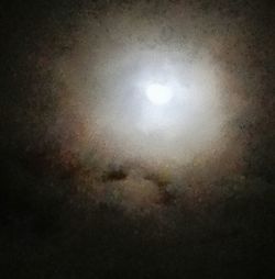 Low angle view of illuminated lights against sky at night