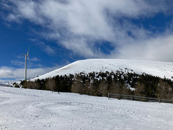 Snow covered field against sky