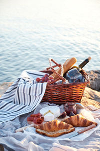 High angle view of food in basket by lake