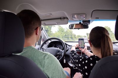 Rear view of people sitting in car