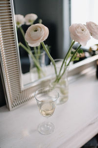 Close-up of rose in glass vase on table