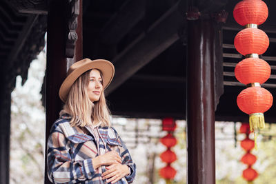 Portrait of young woman wearing hat