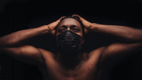 Close-up of shirtless man wearing mask