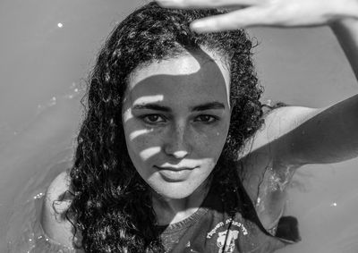 Portrait of smiling young woman in water