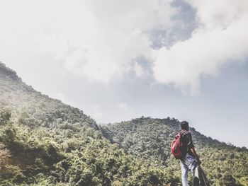 Man standing on mountain against sky