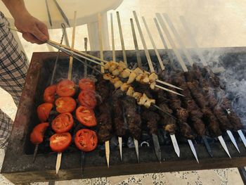 Cropped hand of man preparing food on table