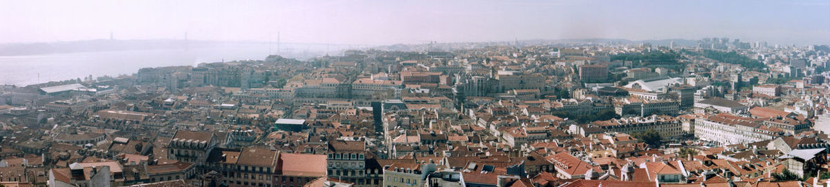 High angle view of cityscape by sea against sky