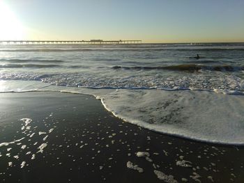 Scenic view of beach against clear sky