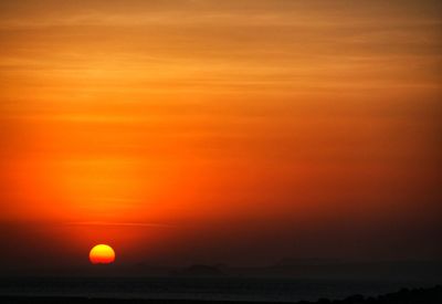 Scenic view of sea against romantic sky at sunset