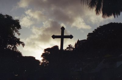 Low angle view of silhouette cross against sky at sunset