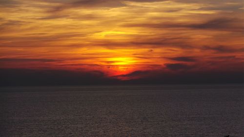 Scenic view of sea against romantic sky at sunset