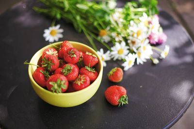 High angle view of strawberries in bowl on table