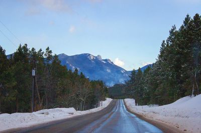 Snow covered landscape against sky