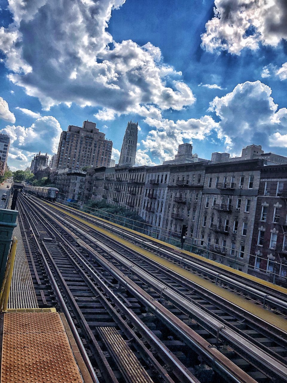 cloud - sky, built structure, sky, building exterior, architecture, railroad track, track, rail transportation, city, transportation, public transportation, mode of transportation, no people, nature, day, building, office building exterior, travel, tower, skyscraper, outdoors