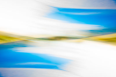 Defocused image of road against blue sky