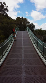Rear view of woman on steps against sky