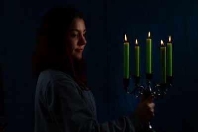 Close-up of teenage girl in the dark