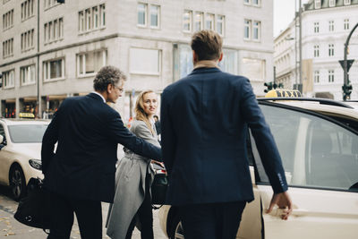 Male and female executives traveling together for business trip